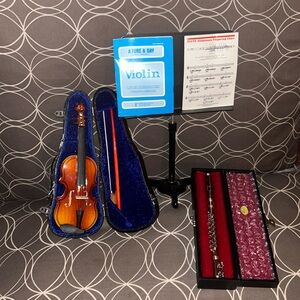 American girl, doll, musical flute, and violin